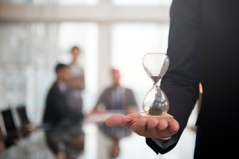 businessman-holding-an-hour-glass-signifies-the-importance-of-being-on-time.jpg